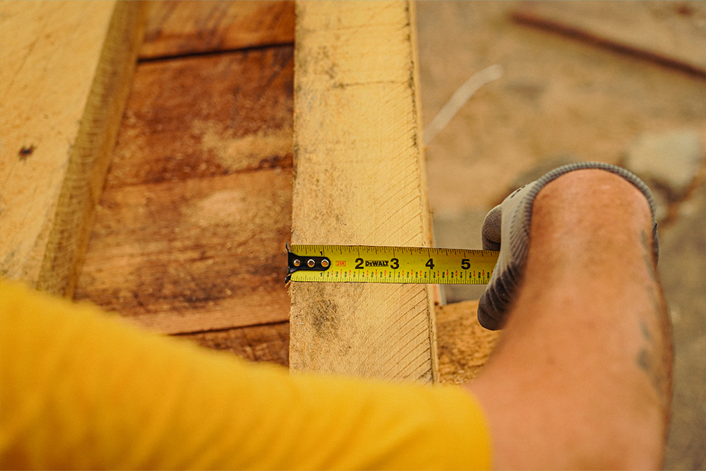 Close-up of a measuring tape on a wooden pallet.